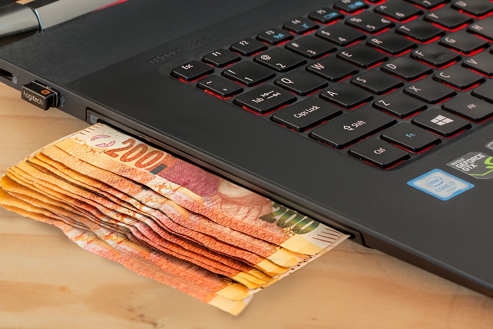 money under laptop